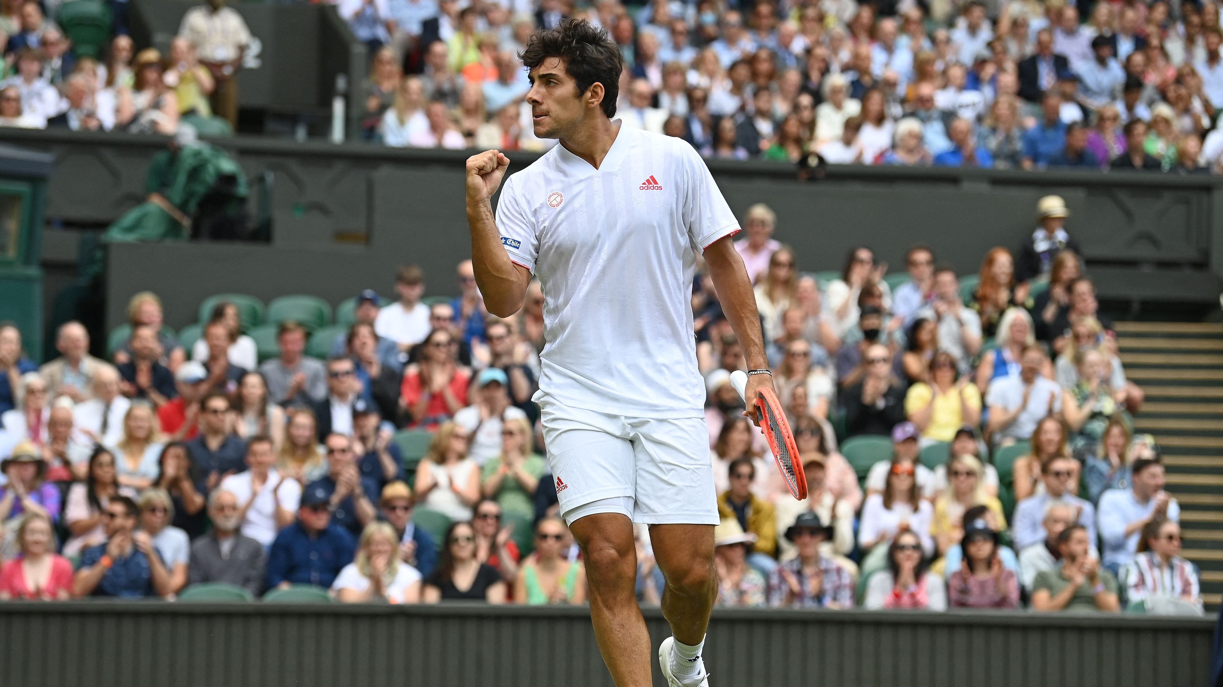 Chile's Cristian Garin celebrates winning a point against Serbia's Novak Djokovic during their men's singles fourth round match on the seventh day of the 2021 Wimbledon Championships at The All England Tennis Club in Wimbledon, southwest London, on July 5, 2021. - RESTRICTED TO EDITORIAL USE (Photo by Glyn KIRK / AFP) / RESTRICTED TO EDITORIAL USE (Photo by GLYN KIRK/AFP via Getty Images)