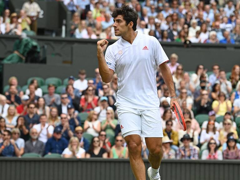 Chile's Cristian Garin celebrates winning a point against Serbia's Novak Djokovic during their men's singles fourth round match on the seventh day of the 2021 Wimbledon Championships at The All England Tennis Club in Wimbledon, southwest London, on July 5, 2021. - RESTRICTED TO EDITORIAL USE (Photo by Glyn KIRK / AFP) / RESTRICTED TO EDITORIAL USE (Photo by GLYN KIRK/AFP via Getty Images)
