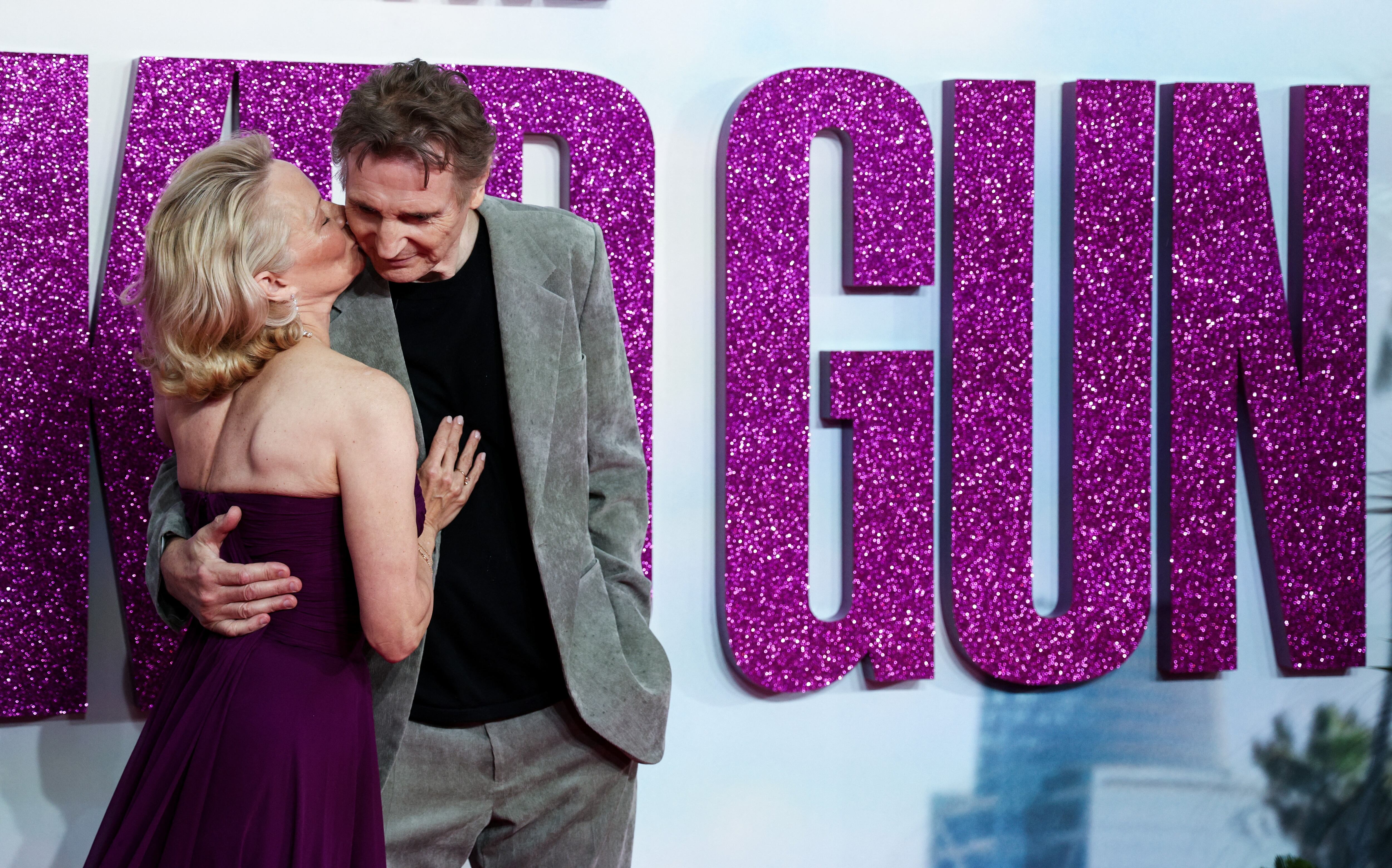 US actress Pamela Anderson (L) and British actor Liam Neeson (R) pose on the red carpet upon arrival for the UK Premier of "Naked Gun" in Leicester Square, central London, on July 22, 2025. (Photo by Adrian DENNIS / AFP) (Photo by ADRIAN DENNIS/AFP via Getty Images)