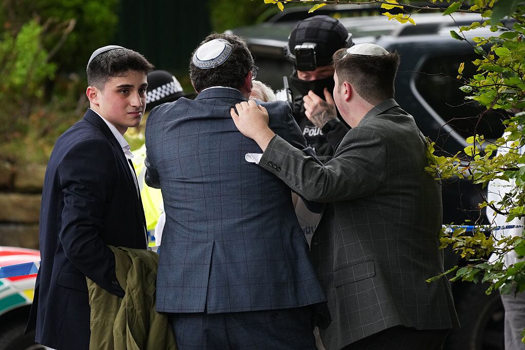 MANCHESTER, ENGLAND - OCTOBER 2: Members of the public and congregants seen as Police and other emergency responders attend the Heaton Park Hebrew Congregation Synagogue, where multiple were injured after stabbing and car attack on Yom Kippur, on October 2, 2025 in the Crumpsall suburb of Manchester, England. Greater Manchester Police said they were called to the scene shortly after 9:30 AM, when a witness said the assailant drove a car at people and then stabbed someone. Police then shot the suspected attacker. (Photo by Christopher Furlong/Getty Images)