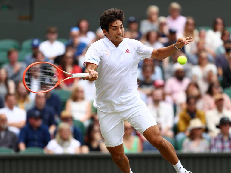 LONDON, ENGLAND - JULY 05: Cristian Garin of Chile stretches to play a forehand in his Men's Singles Fourth Round match against Novak Djokovic of Serbia during Day Seven of The Championships - Wimbledon 2021 at All England Lawn Tennis and Croquet Club on July 05, 2021 in London, England. (Photo by Julian Finney/Getty Images)