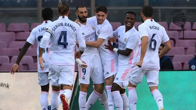 Real Madrid's players celebrate after scoring a goal during the Spanish League football match between Barcelona and Real Madrid at the Camp Nou stadium in Barcelona on October 24, 2020. (Photo by LLUIS GENE / AFP) (Photo by LLUIS GENE/AFP via Getty Images)