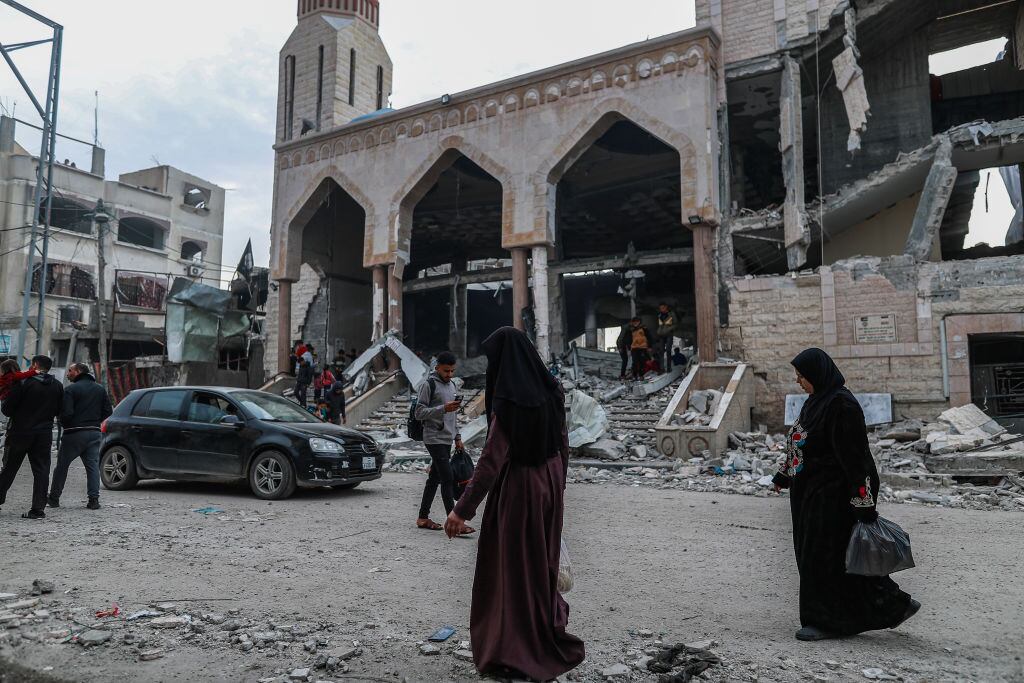 Las personas observan la destrucción de una mezquita en la zona de Rafah, producto de los ataques de Israel sobre la Franja de Gaza en Palestina.