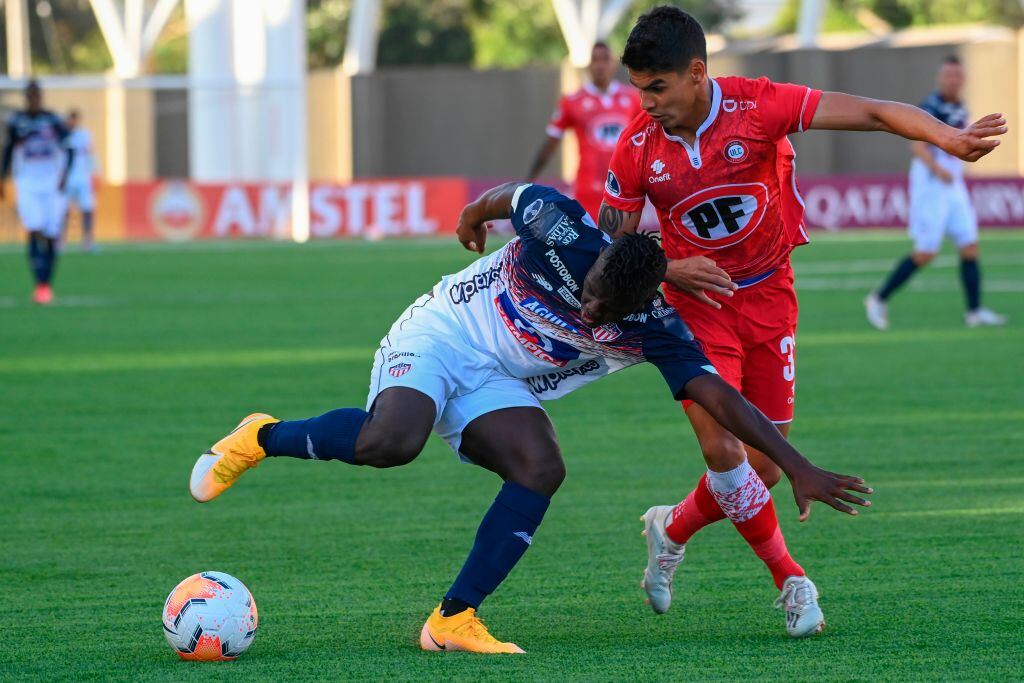 Colombia's Junior Edwuin Cetre (L) and Chile's Union La Calera Erick Wiemberg vie for the ball during their closed-door Copa Sudamericana round before the quarterfinals football match at the Nicolas Chahuan Municipal Stadium in La Calera, Chile, on December 3, 2020. (Photo by MARTIN BERNETTI / AFP) (Photo by MARTIN BERNETTI/AFP via Getty Images)