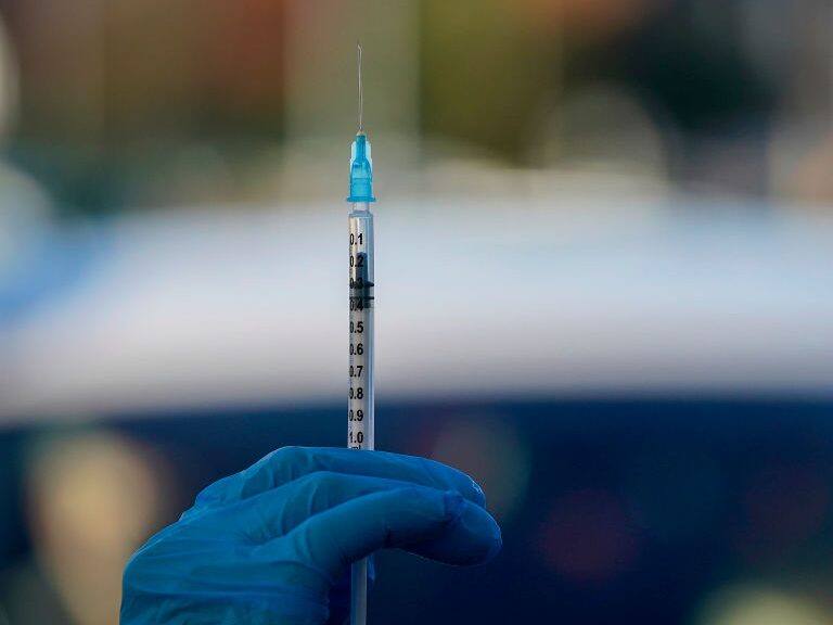 MANCHESTER, ENGLAND - DECEMBER 17: A nurse prepares to administer the Pfizer/BioNTech vaccine at a drive-thru COVID-19 vaccination centre in Hyde on December 17, 2020 in Manchester, England. The coronavirus drive-through vaccine centre is believed to be the first in the world. (Photo by Christopher Furlong/Getty Images)