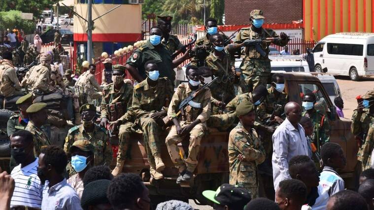 Sudanese security forces keep watch as they protect a military hospital and government offices during protests against a military coup overthrowing the transition to civilian rule on October 25, 2021 in the capital's twin city of Omdurman. - Sudan's top general declared a state of emergency and dissolved the authorities leading the country's democratic transition today, after soldiers detained civilian leaders in what the UN condemned as a "coup". (Photo by AFP) (Photo by -/AFP via Getty Images)