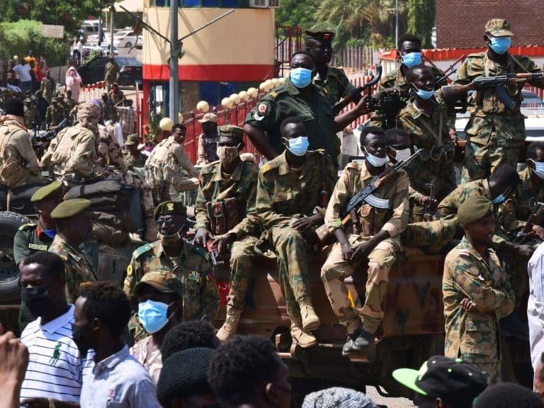 Sudanese security forces keep watch as they protect a military hospital and government offices during protests against a military coup overthrowing the transition to civilian rule on October 25, 2021 in the capital's twin city of Omdurman. - Sudan's top general declared a state of emergency and dissolved the authorities leading the country's democratic transition today, after soldiers detained civilian leaders in what the UN condemned as a "coup". (Photo by AFP) (Photo by -/AFP via Getty Images)