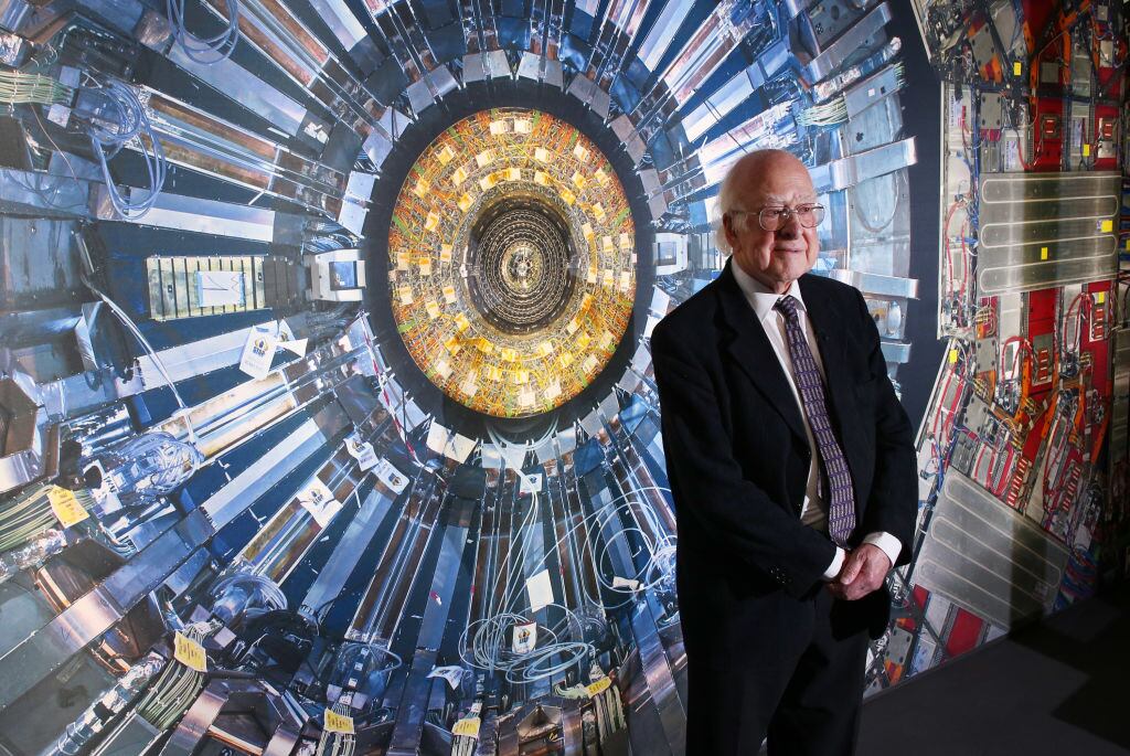 LONDON, ENGLAND - NOVEMBER 12: Professor Peter Higgs stands in front of a photograph of the Large Hadron Collider at the Science Museum's 'Collider' exhibition on November 12, 2013 in London, England. At the exhibition, which opens to the public on November 13, 2013 visitors will see a theatre, video and sound art installation and artefacts from the Large Hadron Collider, providing a behind-the-scenes look at the CERN particle physics laboratory in Geneva. It touches on the discovery of the Higgs boson, or God particle, the realisation of scientist Peter Higgs theory. (Photo by Peter Macdiarmid/Getty Images)