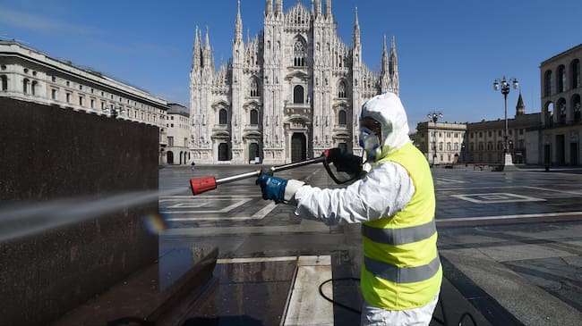 Un trabajador sanitiza una plaza de Milán