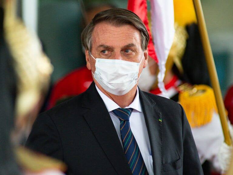 BRASILIA, BRAZIL - DECEMBER 16: Brazilian President Jair Bolsonaro looks on after inauguration of newly appointed Minister of Federal Supreme Tribunal Andre Luiz de Almeida Mendonça on December 16, 2021 in Brasilia, Brazil. Former Justice Minister Mendonça had been nominated by President Jair Bolsonaro and then approved by Brazilian senate to fill a vacant position on the supreme court. (Photo by Andressa Anholete/Getty Images)