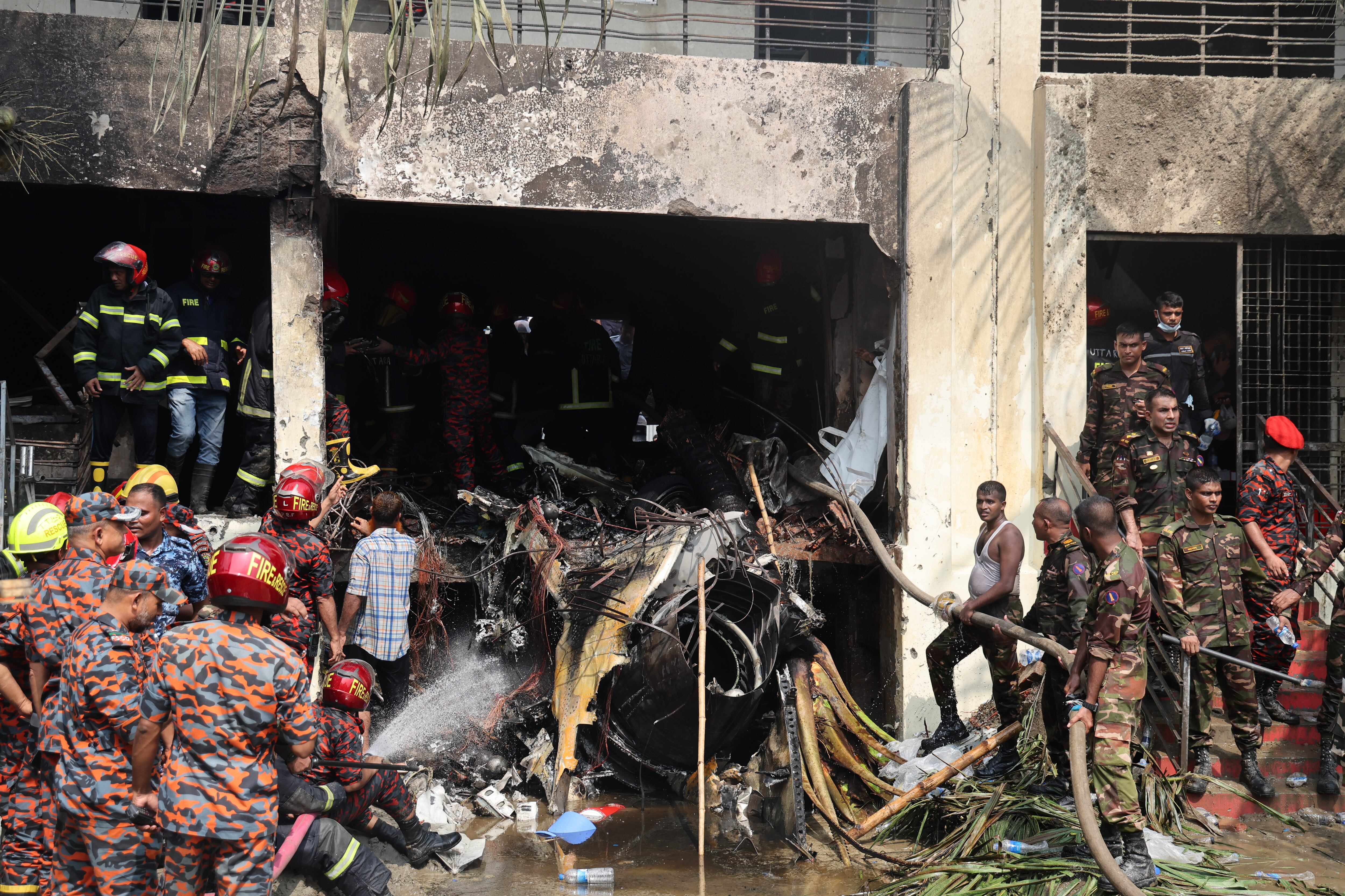 DHAKA, BANGLADESH - JULY 21: Members of the Bangladesh Army and the fire service start rescue operations after a Bangladesh Air Force F7 aircraft crashed into a building of Milestone College in Dhaka's Uttara around 1:30 pm on July 21, 2025 in Dhaka, Bangladesh. At least 16 people have died, including the pilot of the aircraft. (Photo by Abdul Goni/Drik/Getty Images)