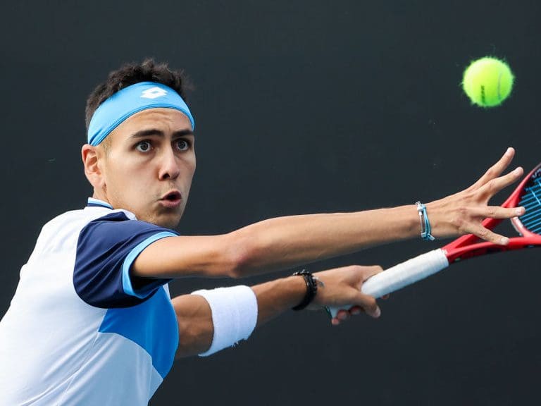 Chile&#039;s Alejandro Tabilo hits a return against John Isner of the US during their men&#039;s singles match on day four of the Australian Open tennis tournament in Melbourne on January 23, 2020. (Photo by DAVID GRAY / AFP) / IMAGE RESTRICTED TO EDITORIAL USE - STRICTLY NO COMMERCIAL USE (Photo by DAVID GRAY/AFP via Getty Images)