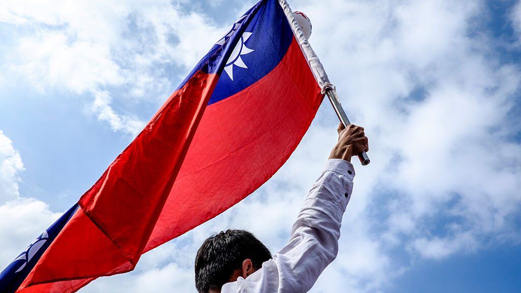 Retired government employee hold a national flag while marching through the streets during a protest in Taipei on September 3, 2016.More than 200,000 people, mostly civil servants, took to Taipei's streets on September 3 in protest over planned reforms to the island's struggling pension system, for which they say they are unfairly blamed. The massive demonstration was the latest challenge to President Tsai Ing-wen's new government, which has seen its popularity ratings fall rapidly since taking the helm in May. (Photo by Jose Lopes Amaral/NurPhoto via Getty Images)