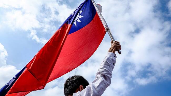 Retired government employee hold a national flag while marching through the streets during a protest in Taipei on September 3, 2016.More than 200,000 people, mostly civil servants, took to Taipei's streets on September 3 in protest over planned reforms to the island's struggling pension system, for which they say they are unfairly blamed. The massive demonstration was the latest challenge to President Tsai Ing-wen's new government, which has seen its popularity ratings fall rapidly since taking the helm in May. (Photo by Jose Lopes Amaral/NurPhoto via Getty Images)