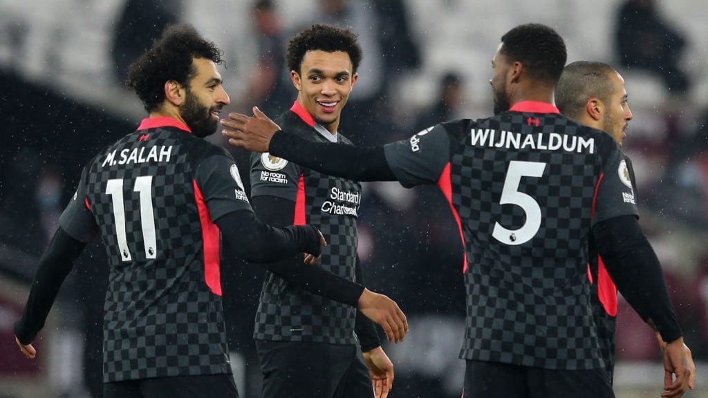 LONDON, ENGLAND - JANUARY 31: Mohamed Salah of Liverpool celebrates scoring the opening goal with team mates Trent Alexander-Arnold and Georginio Wijnaldum during the Premier League match between West Ham United and Liverpool at London Stadium on January 31, 2021 in London, United Kingdom. Sporting stadiums around the UK remain under strict restrictions due to the Coronavirus Pandemic as Government social distancing laws prohibit fans inside venues resulting in games being played behind closed doors. (Photo by Craig Mercer/MB Media/Getty Images)