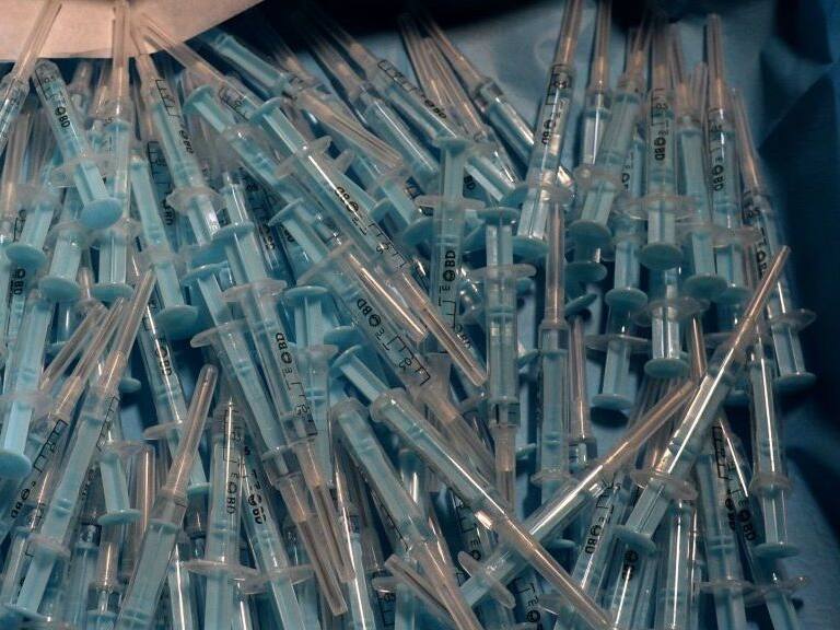 Syringes are pictured at a drive-through coronavirus vaccination centre at the Nuevo Colombino stadium in Huelva on March 22, 2021. - Spain raised the maximum age limit for people to receive the AstraZeneca vaccine, which has faced setbacks in Europe due to safety concerns, from 55 to 65. (Photo by CRISTINA QUICLER / AFP) (Photo by CRISTINA QUICLER/AFP via Getty Images)