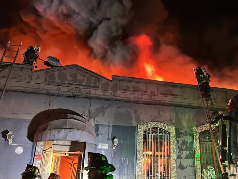 Violento incendio consume una bodega y un hotel abandonado en Santiago: tres bomberos resultaron heridos
