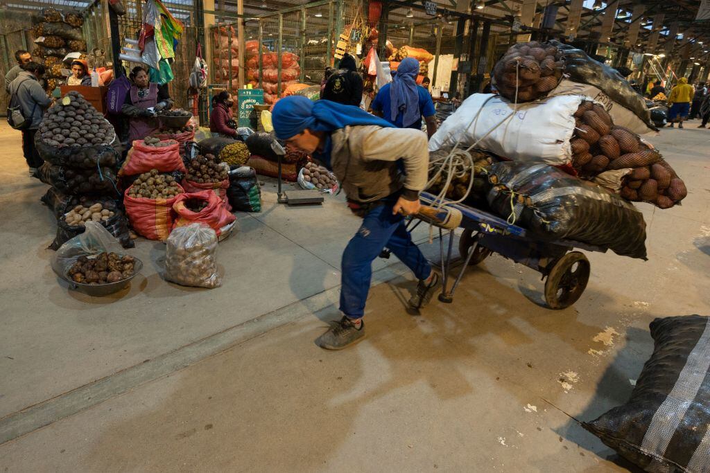 Un trabajador traslada sacos en el mercado Santa Anita de Lima en Perú
