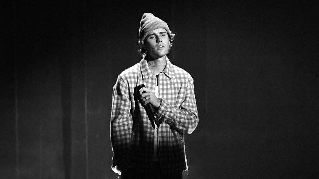 LOS ANGELES, CALIFORNIA - NOVEMBER 22: (EDITORS NOTE: Image has been converted to black and white. A color version is available.) In this image released on November 22, Justin Bieber performs onstage for the 2020 American Music Awards at Microsoft Theater on November 22, 2020 in Los Angeles, California. (Photo by Kevin Mazur/AMA2020/Getty Images for dcp)