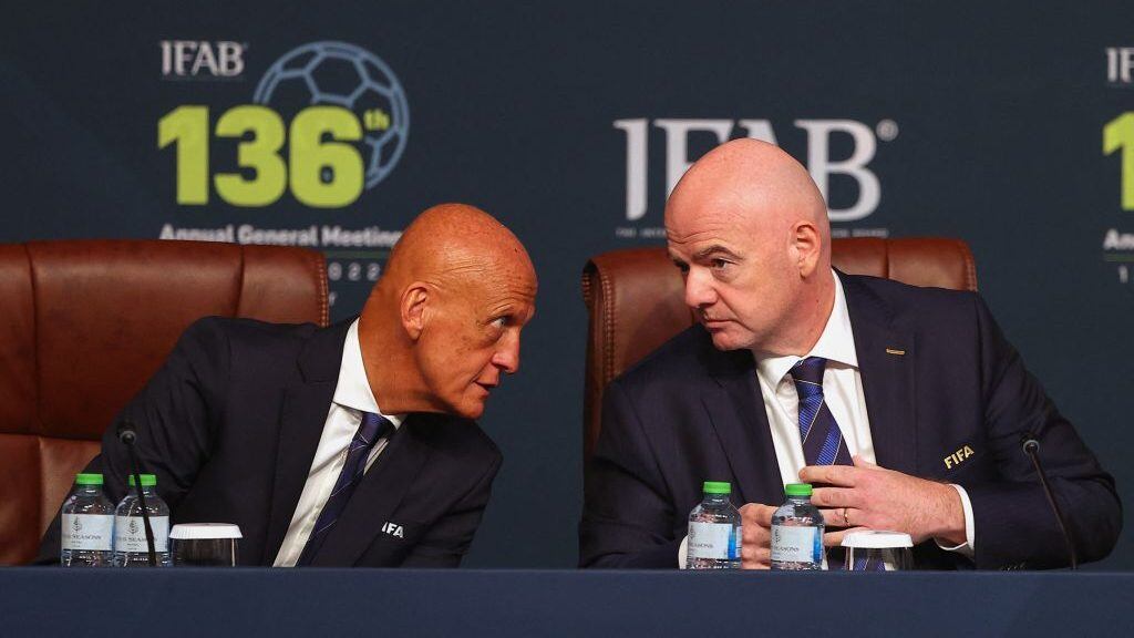FIFA president Gianni Infantino (R) chats with FIFA referees committee chairm Pierluigi Collina (L) during the 137th International Football Association Board (IFAB) meeting in the Qatari capital Doha on June 13, 2022. - Football's rules body today said that five substitutes would be permanently introduced for all top games and that an automatic offside detector is closer to being introduced for this year's World Cup. (Photo by KARIM JAAFAR / AFP) (Photo by KARIM JAAFAR/AFP via Getty Images)