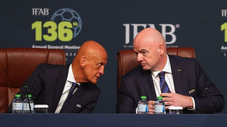 FIFA president Gianni Infantino (R) chats with FIFA referees committee chairm Pierluigi Collina (L) during the 137th International Football Association Board (IFAB) meeting in the Qatari capital Doha on June 13, 2022. - Football's rules body today said that five substitutes would be permanently introduced for all top games and that an automatic offside detector is closer to being introduced for this year's World Cup. (Photo by KARIM JAAFAR / AFP) (Photo by KARIM JAAFAR/AFP via Getty Images)