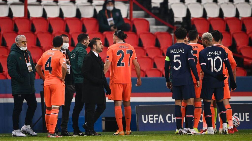 Istanbul Basaksehir's Turkish coach Okan Buruk (3rdL front) stands on the sideline as players argue during the UEFA Champions League group H football match between Paris Saint-Germain (PSG) and Istanbul Basaksehir FK at the Parc des Princes stadium in Paris, on December 8, 2020. (Photo by FRANCK FIFE / AFP) (Photo by FRANCK FIFE/AFP via Getty Images)
