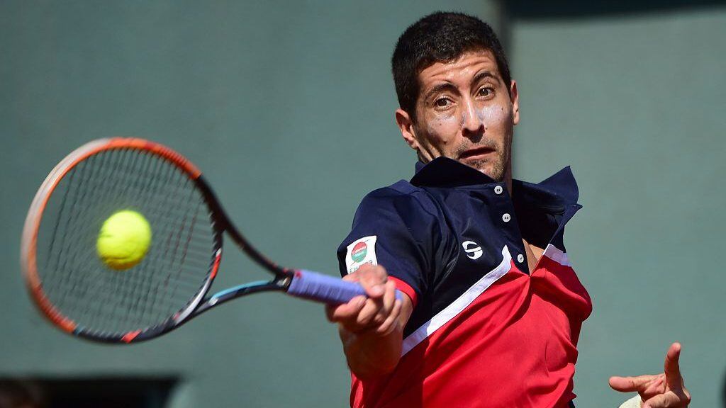 Chile's Hans Podlipnik returns the ball to Dominican Republic's Jose Olivares during a Davis Cup American group zone 1 tennis match at the National Stadium in Santiago on March 04, 2016. AFP PHOTO MARTIN BERNETTI / AFP / MARTIN BERNETTI (Photo credit should read MARTIN BERNETTI/AFP via Getty Images)