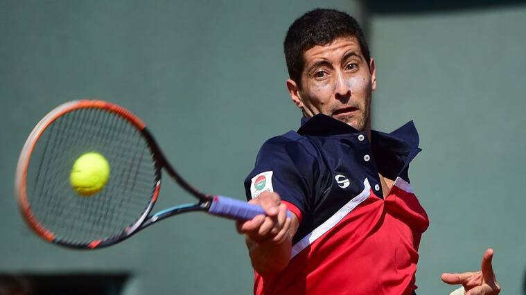 Chile's Hans Podlipnik returns the ball to Dominican Republic's Jose Olivares during a Davis Cup American group zone 1 tennis match at the National Stadium in Santiago on March 04, 2016. AFP PHOTO MARTIN BERNETTI / AFP / MARTIN BERNETTI (Photo credit should read MARTIN BERNETTI/AFP via Getty Images)