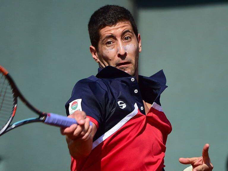Chile's Hans Podlipnik returns the ball to Dominican Republic's Jose Olivares during a Davis Cup American group zone 1 tennis match at the National Stadium in Santiago on March 04, 2016. AFP PHOTO MARTIN BERNETTI / AFP / MARTIN BERNETTI (Photo credit should read MARTIN BERNETTI/AFP via Getty Images)