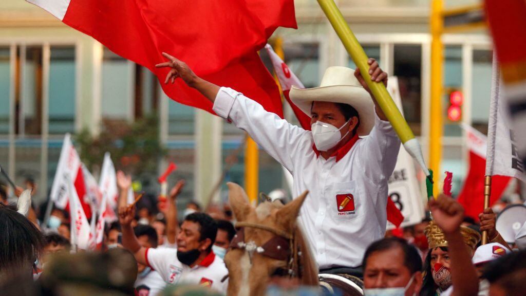 Peruvian presidential candidate for the radical leftist party Peru Libre (Free Peru), Pedro Castillo, rides a horse holding a giant pencil during the closing rally of his campaign in Lima on April 8, 2021. - Castillo 51-year-old school teacher native of Cajamarca, aspires to surprise the elections in Peru, after leaving anonymity in 2017 by leading a long strike by the teachers. He gained prominence with options to move on to the decisive second round, during the electoral debates, according to the polls. (Photo by Gian MASKO / AFP) (Photo by GIAN MASKO/AFP via Getty Images)