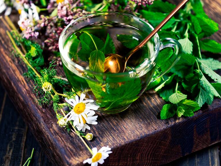 A the cup of lemon balm tea on the wooden table