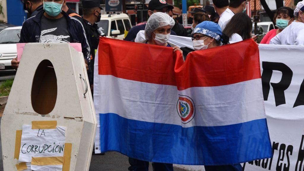 Health workers take part in a protest to demand the government to comply with their requests for medical supplies and materials amid the new coronavirus pandemic, as well as better conditions for those infected with COVID-19, in Asuncion, on November 19, 2020. (Photo by NORBERTO DUARTE / AFP) (Photo by NORBERTO DUARTE/AFP via Getty Images)