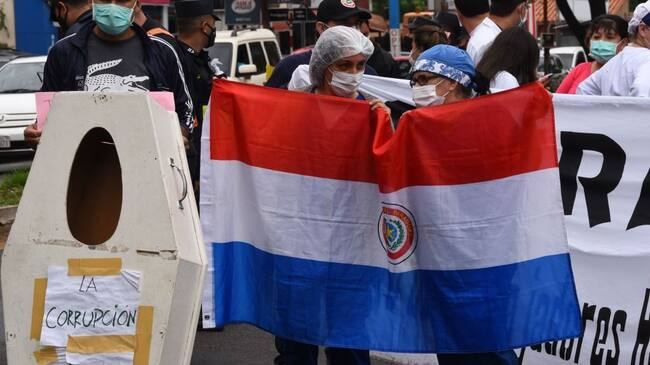 Health workers take part in a protest to demand the government to comply with their requests for medical supplies and materials amid the new coronavirus pandemic, as well as better conditions for those infected with COVID-19, in Asuncion, on November 19, 2020. (Photo by NORBERTO DUARTE / AFP) (Photo by NORBERTO DUARTE/AFP via Getty Images)