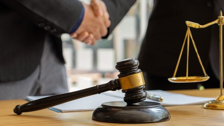 Good service, male business man consultation, shaking hands, male lawyer or judge adviser.Have a team meeting with clients, legal ideas in the office.