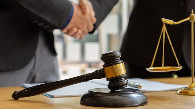 Good service, male business man consultation, shaking hands, male lawyer or judge adviser.Have a team meeting with clients, legal ideas in the office.