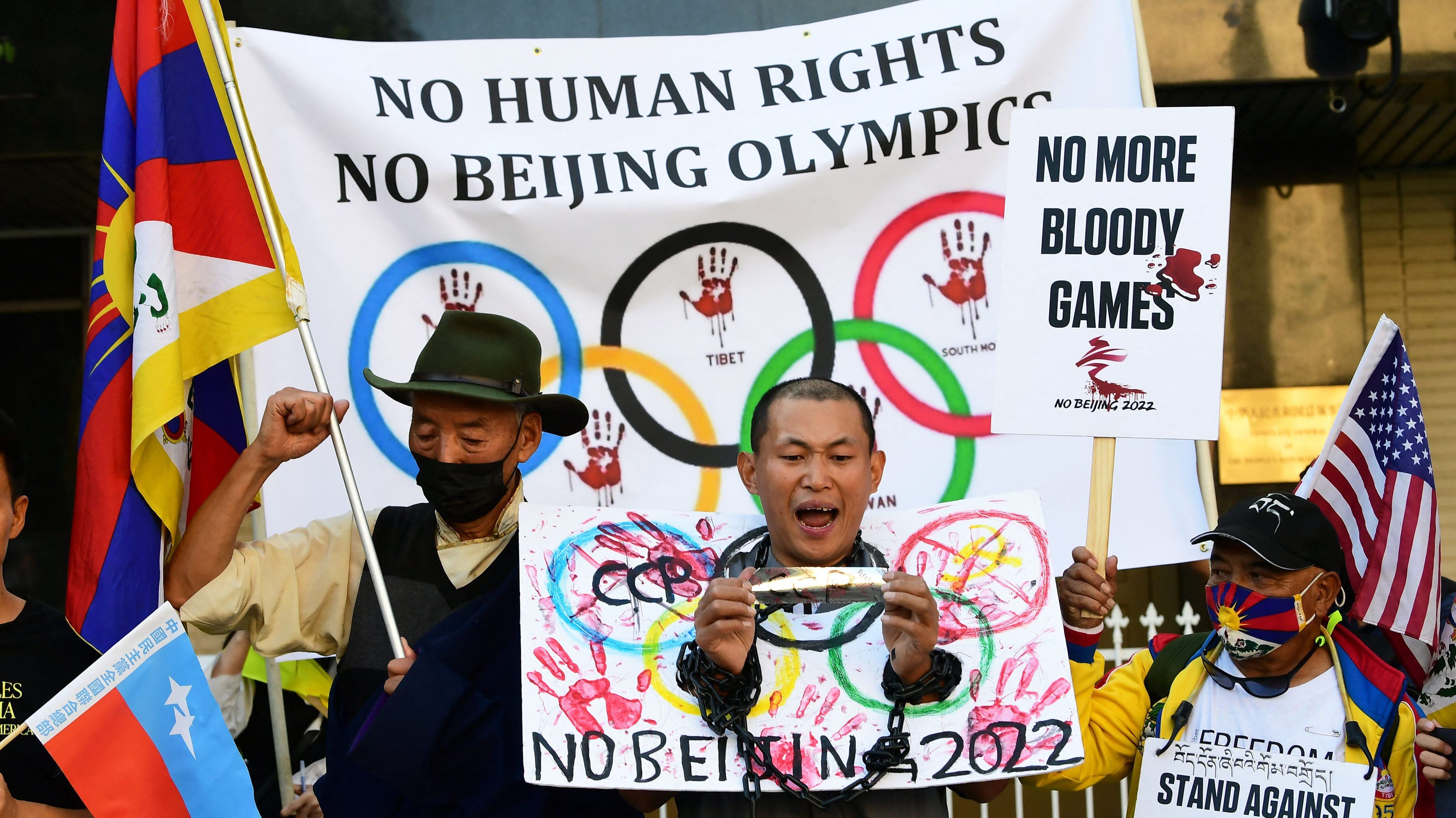Activists rally in front of the Chinese Consulate in Los Angeles, California on November 3, 2021, calling for a boycott of the 2022 Beijing Winter Olympics due to concerns over China's human rights record. - Activists lobbied Olympic broadcasters, including NBC, BBC, CBC and Sky to "immediately cancel broadcasting deals" to televise the Beijing 2022 Winter Olympics or "face risk of being complicit in the Chinese Communist Party's severe and worsening human rights abuses". (Photo by Frederic J. BROWN / AFP) (Photo by FREDERIC J. BROWN/AFP via Getty Images)