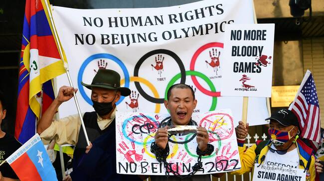 Activists rally in front of the Chinese Consulate in Los Angeles, California on November 3, 2021, calling for a boycott of the 2022 Beijing Winter Olympics due to concerns over China's human rights record. - Activists lobbied Olympic broadcasters, including NBC, BBC, CBC and Sky to "immediately cancel broadcasting deals" to televise the Beijing 2022 Winter Olympics or "face risk of being complicit in the Chinese Communist Party's severe and worsening human rights abuses". (Photo by Frederic J. BROWN / AFP) (Photo by FREDERIC J. BROWN/AFP via Getty Images)
