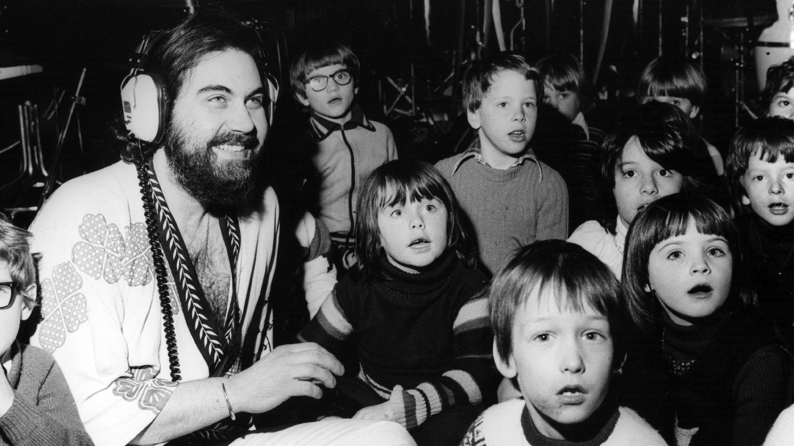 Composer, musician, arranger and producer Evangalos Papathanassiou, better known as Vangelis, records a track for his new album with 25 children from Orleans Infants School in Twickenham. Original Publication: People Disc - HM0406 (Photo by Fred Mott/Getty Images)