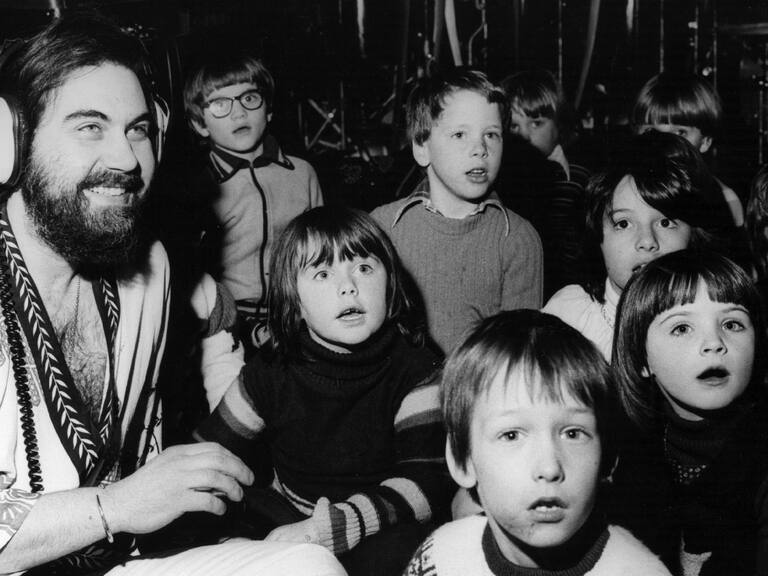 Composer, musician, arranger and producer Evangalos Papathanassiou, better known as Vangelis, records a track for his new album with 25 children from Orleans Infants School in Twickenham. Original Publication: People Disc - HM0406 (Photo by Fred Mott/Getty Images)