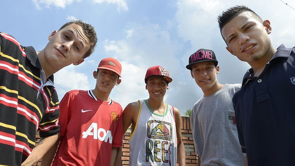 Argentina's cumbia villera band  Los Wachiturros members (L-R) Memo, Leito, Kaka, Brian and Gonza, pose for a picture in their neigborhood after an interview with AFP, in Moron, outskirts of Buenos Aires , on February 15, 2013.  AFP PHOTO / JUAN MABROMATA        (Photo credit should read JUAN MABROMATA/AFP via Getty Images)