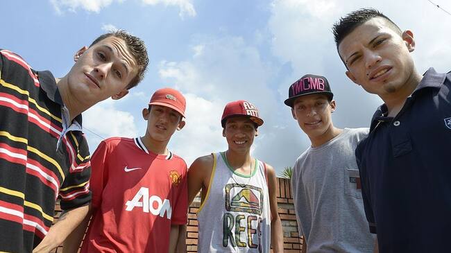 Argentina's cumbia villera band Los Wachiturros members (L-R) Memo, Leito, Kaka, Brian and Gonza, pose for a picture in their neigborhood after an interview with AFP, in Moron, outskirts of Buenos Aires , on February 15, 2013. AFP PHOTO / JUAN MABROMATA (Photo credit should read JUAN MABROMATA/AFP via Getty Images)