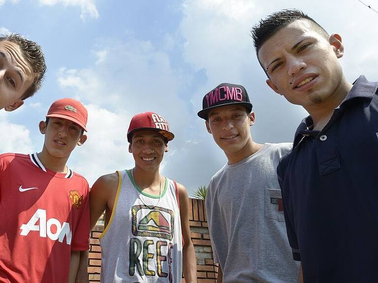 Argentina's cumbia villera band Los Wachiturros members (L-R) Memo, Leito, Kaka, Brian and Gonza, pose for a picture in their neigborhood after an interview with AFP, in Moron, outskirts of Buenos Aires , on February 15, 2013. AFP PHOTO / JUAN MABROMATA (Photo credit should read JUAN MABROMATA/AFP via Getty Images)
