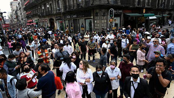 People are seen in the street after an earthquake in Mexico City on September 19, 2022. - A 6.8-magnitude earthquake struck western Mexico on Monday, shaking buildings in Mexico City on the anniversary of two major tremors in 1985 and 2017, seismologists said. (Photo by Alfredo ESTRELLA / AFP) (Photo by ALFREDO ESTRELLA/AFP via Getty Images)