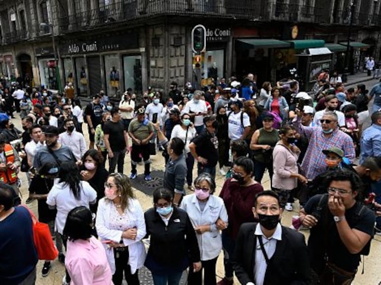 People are seen in the street after an earthquake in Mexico City on September 19, 2022. - A 6.8-magnitude earthquake struck western Mexico on Monday, shaking buildings in Mexico City on the anniversary of two major tremors in 1985 and 2017, seismologists said. (Photo by Alfredo ESTRELLA / AFP) (Photo by ALFREDO ESTRELLA/AFP via Getty Images)