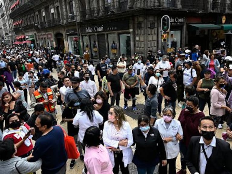 People are seen in the street after an earthquake in Mexico City on September 19, 2022. - A 6.8-magnitude earthquake struck western Mexico on Monday, shaking buildings in Mexico City on the anniversary of two major tremors in 1985 and 2017, seismologists said. (Photo by Alfredo ESTRELLA / AFP) (Photo by ALFREDO ESTRELLA/AFP via Getty Images)