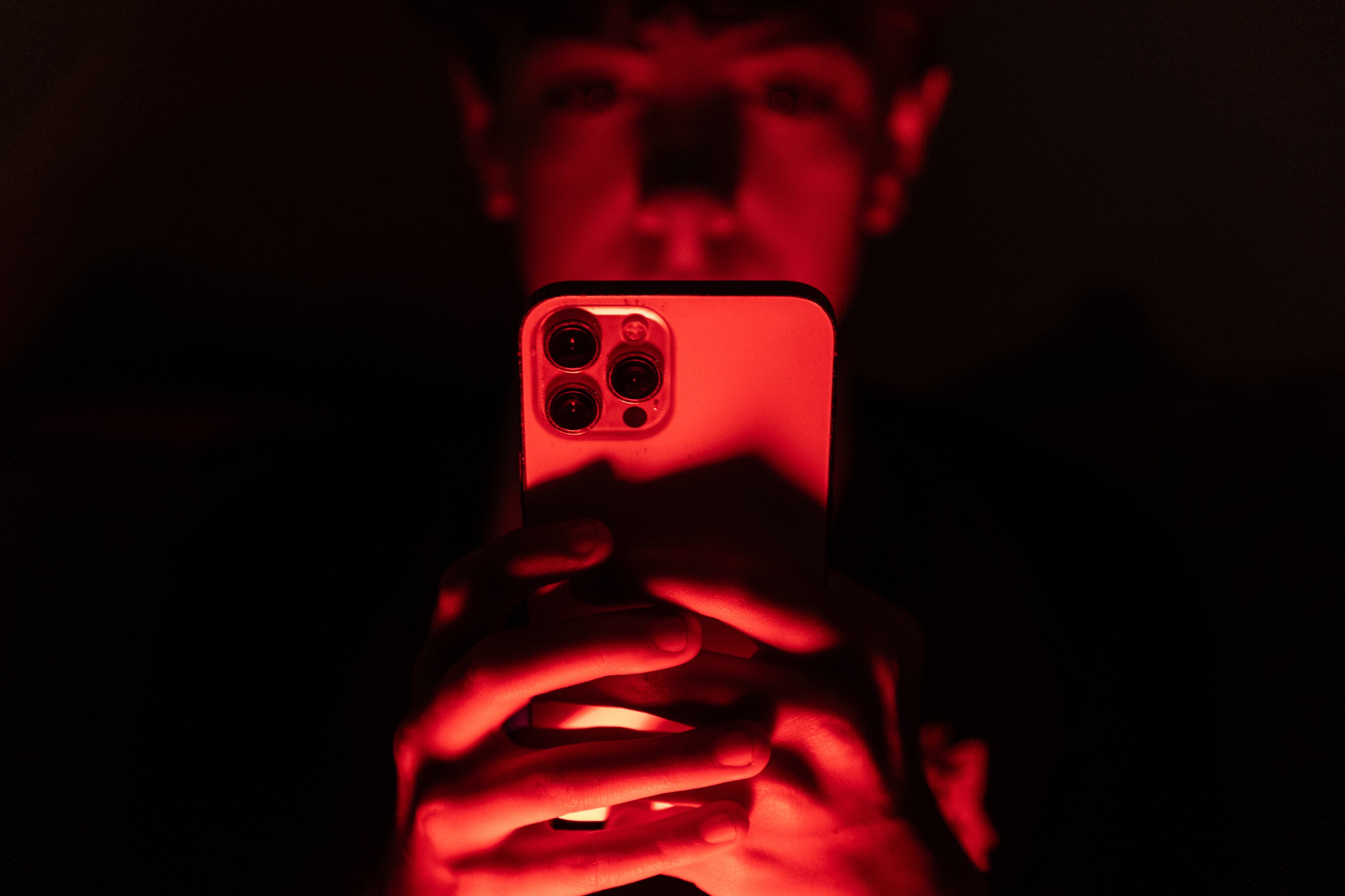 In this photo illustration a 13-year-old teenage boy looks at an iPhone screen. (Photo by Matt Cardy/Getty Images)