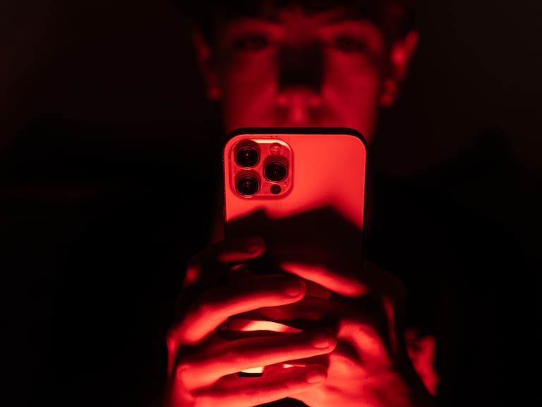 In this photo illustration a 13-year-old teenage boy looks at an iPhone screen. (Photo by Matt Cardy/Getty Images)