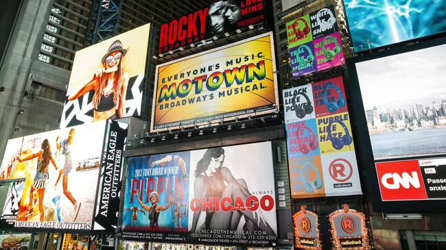 Broadway theater billboards in Times Square at night, New York
