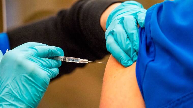 Nurse Susan McCarthy gives front line workers their first shot in the two shot vaccination process at Backus Hospital where 211 doses of the Pfizer BioNTech Covid-19 vaccine were delivered and being given to 30 hospital workers on the first day of vaccinations in Norwich, Connecticut on December 15, 2020. (Photo by Joseph Prezioso / AFP) (Photo by JOSEPH PREZIOSO/AFP via Getty Images)