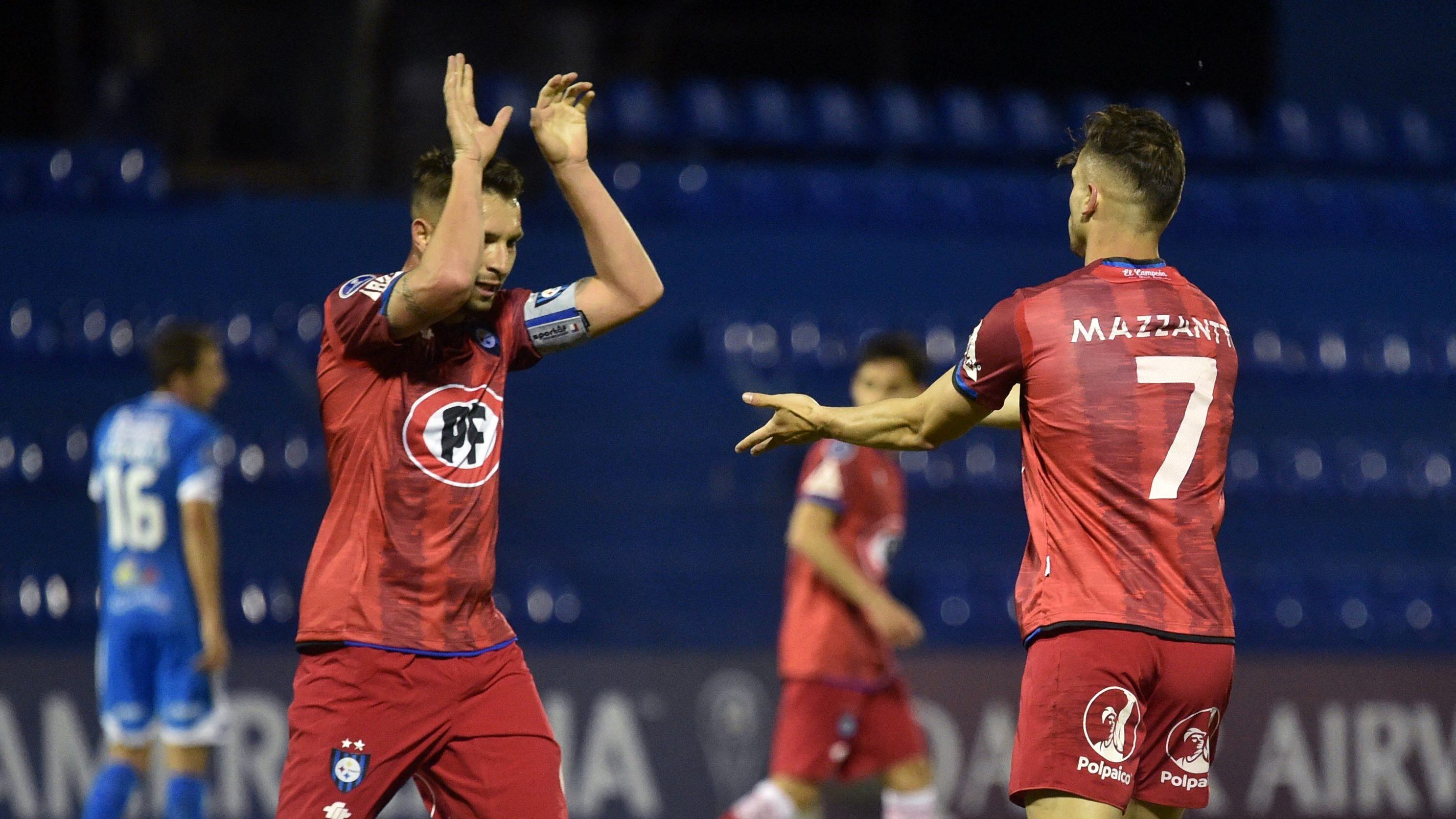 Chile's Huachipato Argentine Walter Mazzantti (R) celebrates with teammate Claudio Sepulveda after scoring against Paraguay's 12 de Octubre during the Copa Sudamericana football tournament group stage match at the Luis Alfonso Giagni stadium in Villa Elisa, Paraguay, on May 12, 2021. (Photo by NORBERTO DUARTE / AFP) (Photo by NORBERTO DUARTE/AFP via Getty Images)